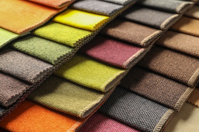 Photo of Fabric samples of different colors for interior design as background