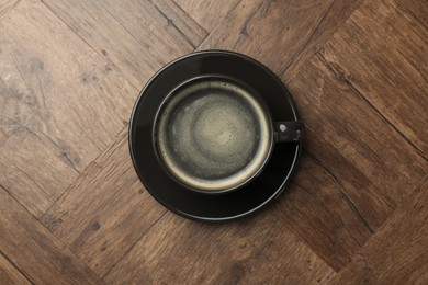 Photo of Hot coffee in cup on wooden table, top view