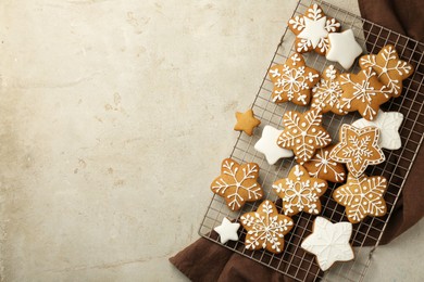 Tasty Christmas cookies with icing on light table, top view. Space for text