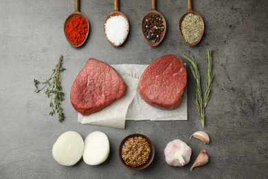 Photo of Flat lay composition with fresh beef cut on grey table