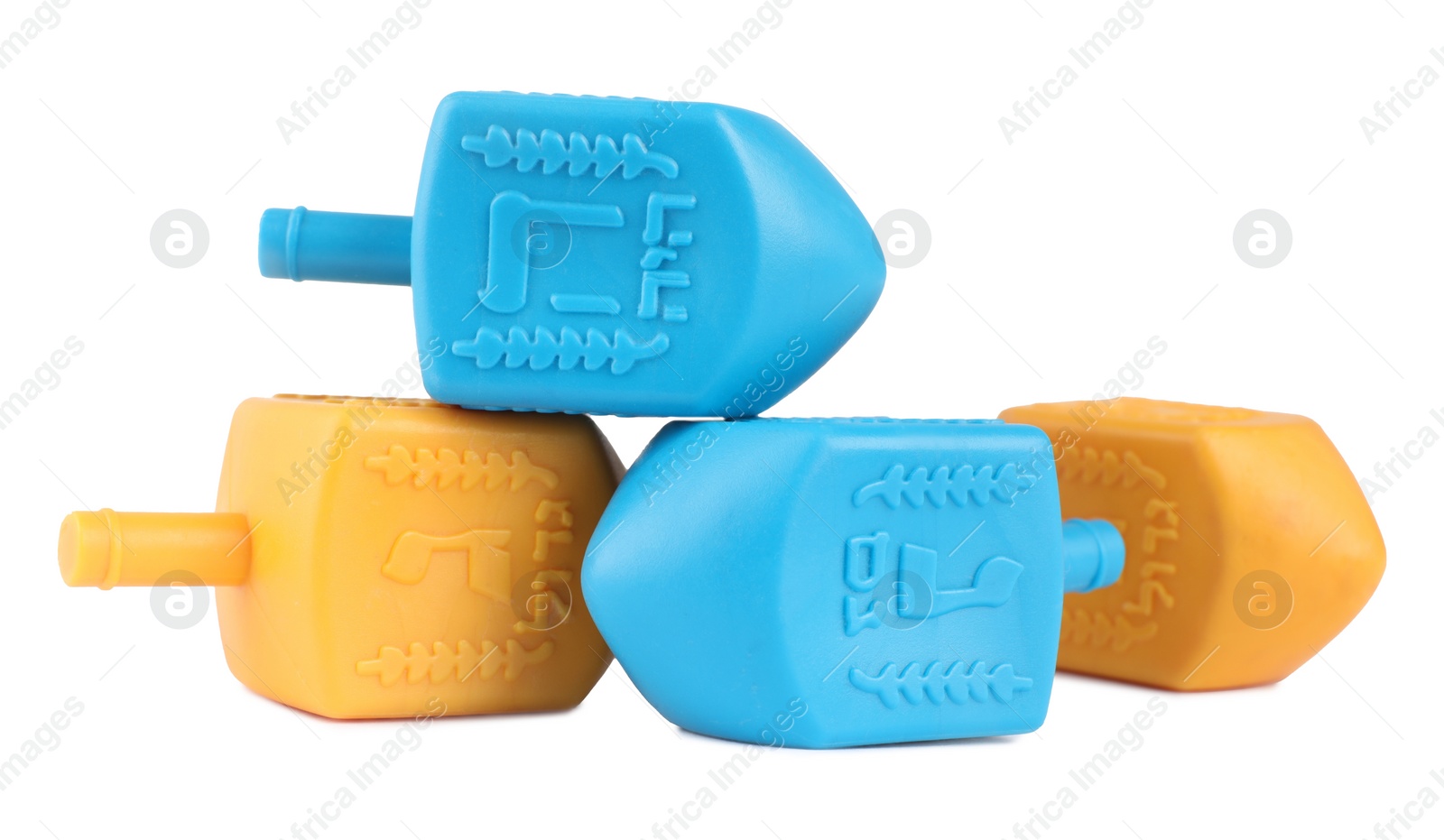 Photo of Hanukkah celebration. Colorful dreidels with jewish letters isolated on white