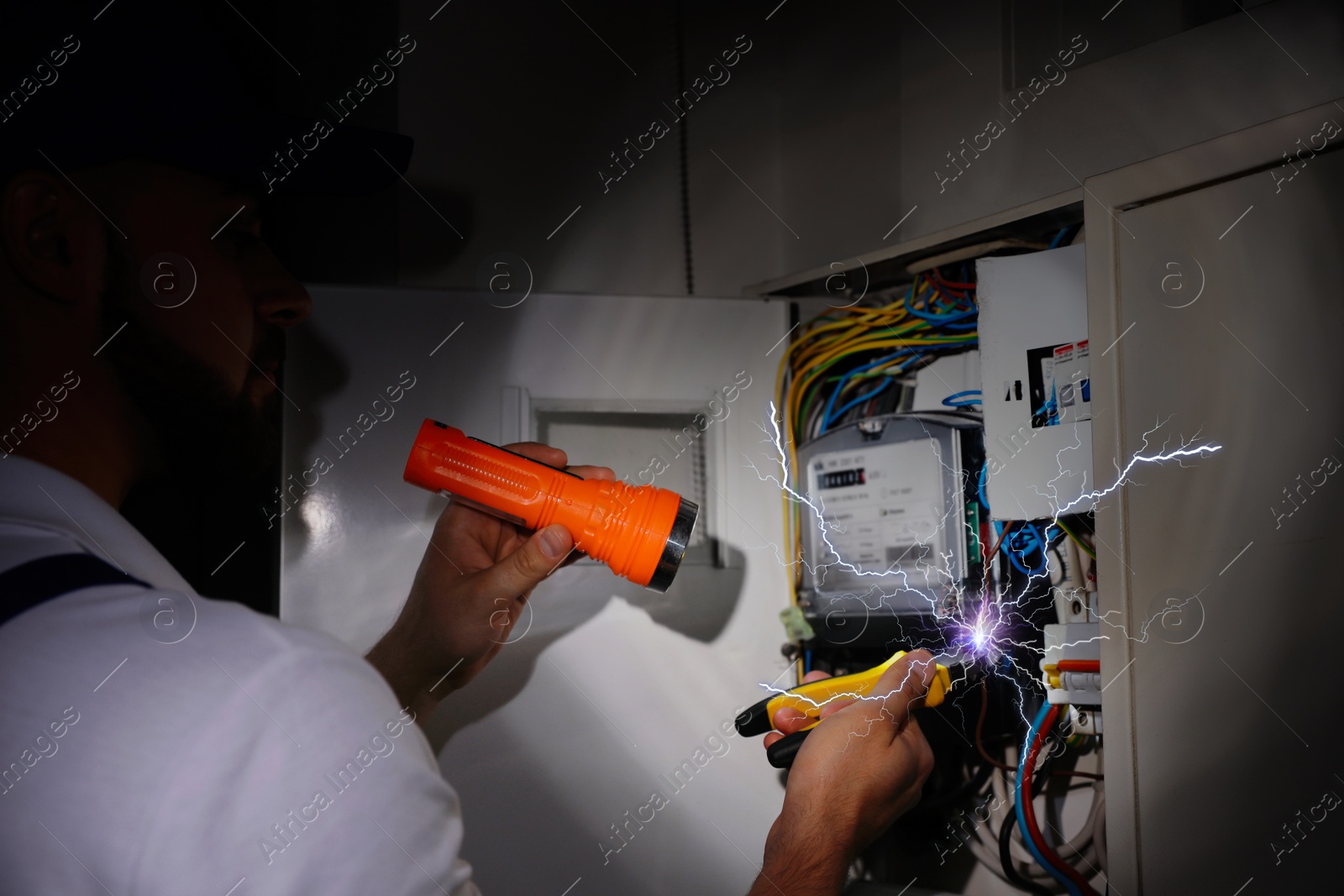 Image of Electrician receiving electric shock while working, closeup