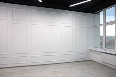 Photo of New empty room with clean windows and light walls