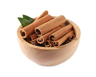 Cinnamon sticks and green leaves in bowl isolated on white