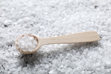 Photo of Natural salt and wooden spoon, closeup view