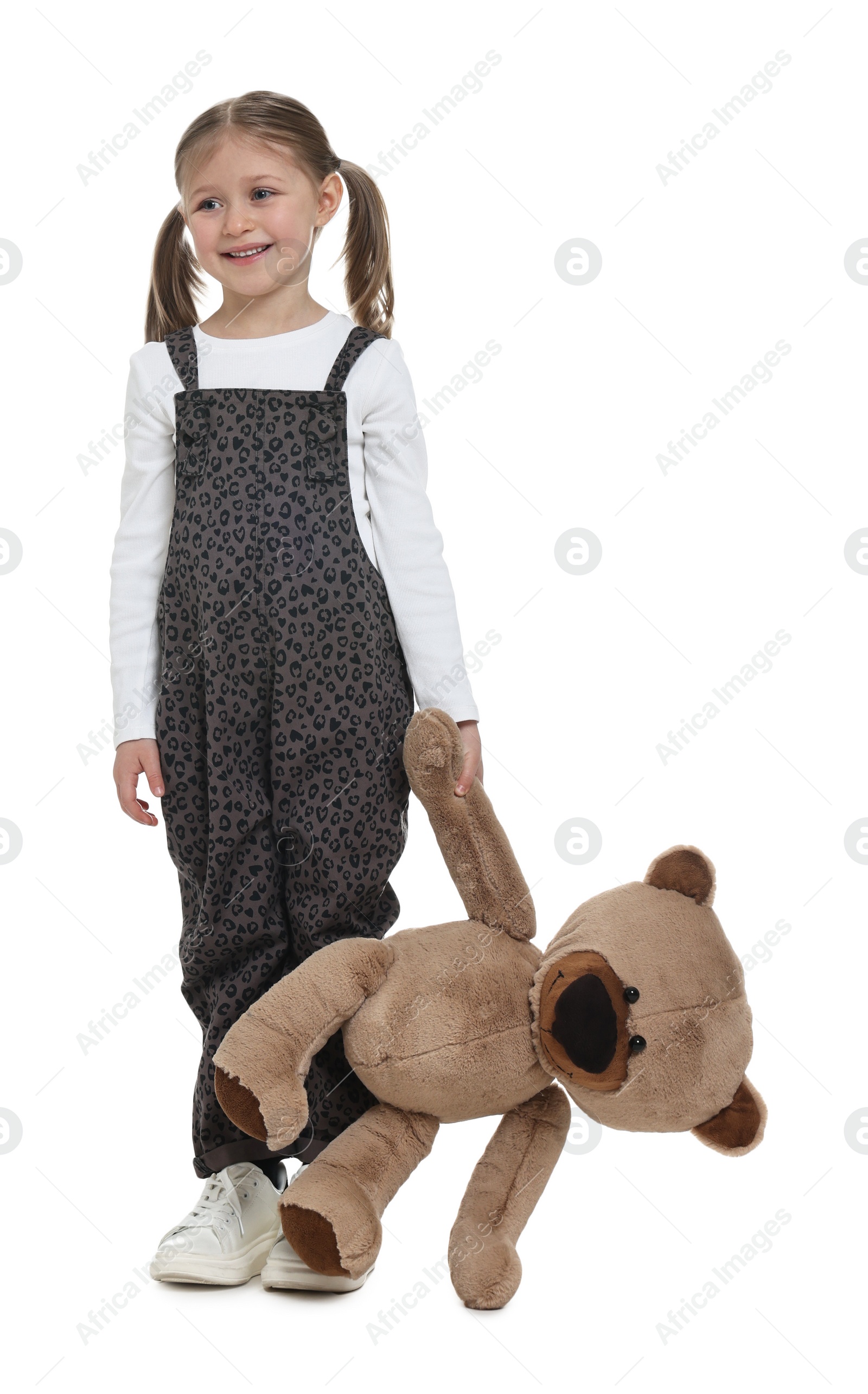 Photo of Cute girl with teddy bear on white background