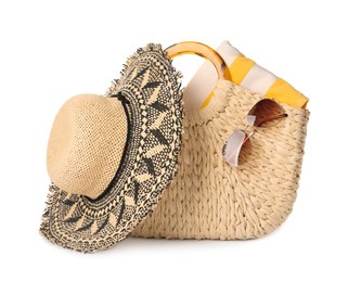 Photo of Stylish straw hat, beach bag and sunglasses on white background