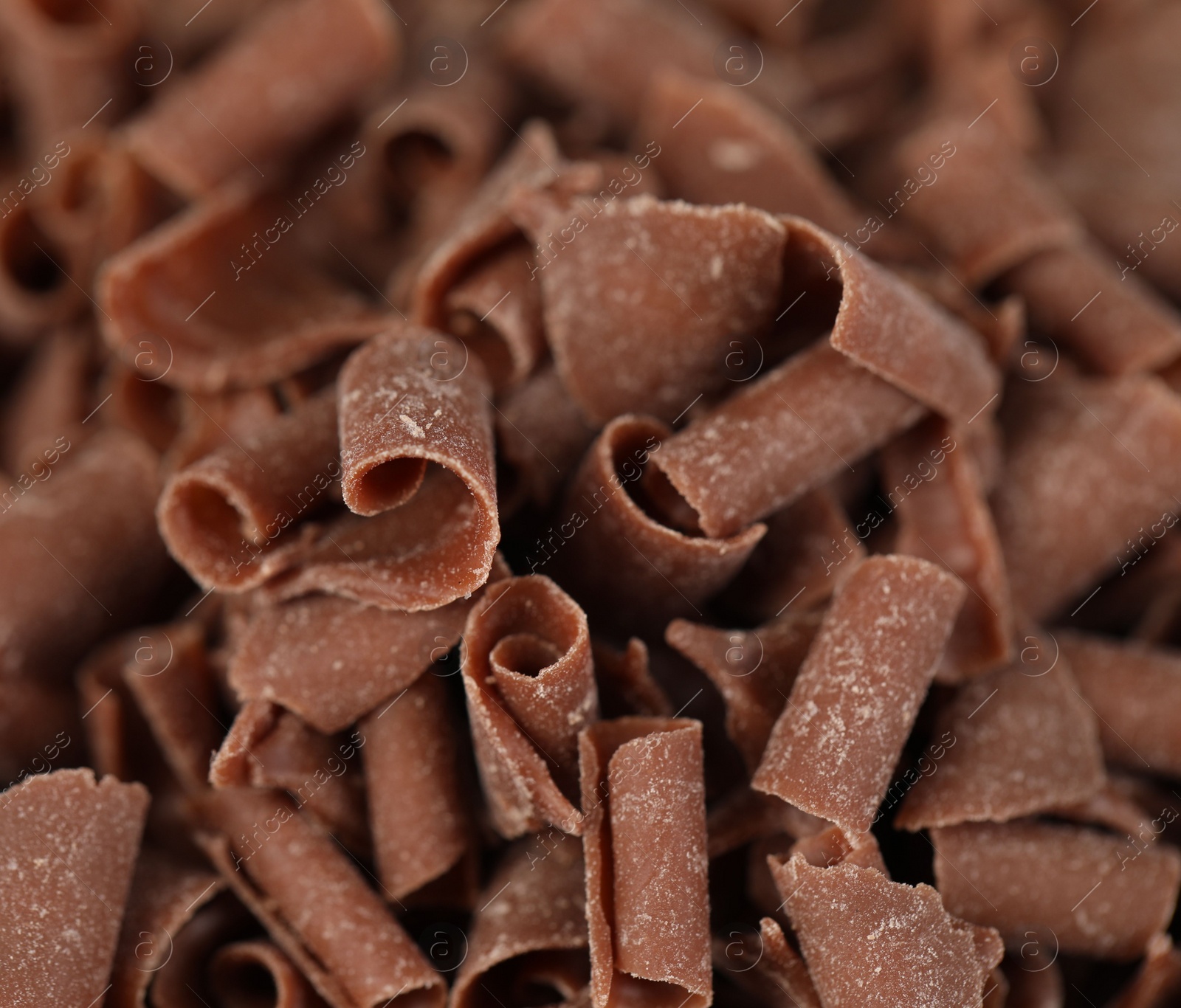 Photo of Many delicious chocolate shavings as background, closeup