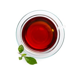 Photo of Glass cup of hot aromatic tea and green leaves on white background, top view