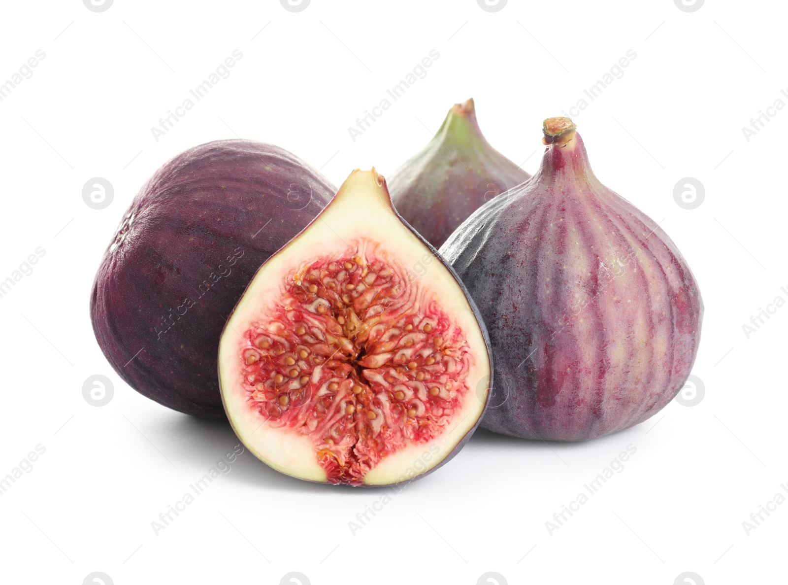 Photo of Whole and cut purple figs on white background