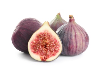 Photo of Whole and cut purple figs on white background