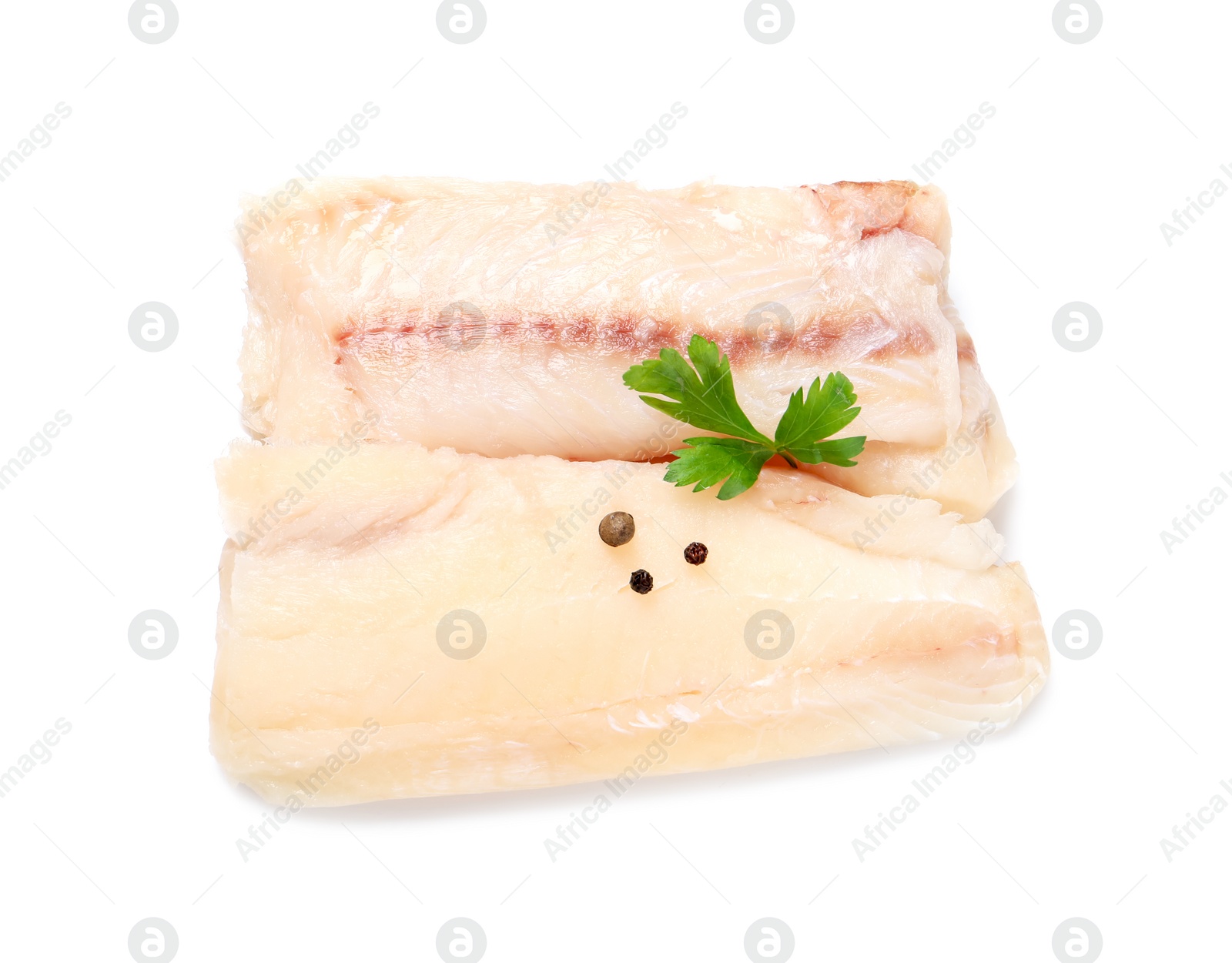 Photo of Pieces of raw cod fish, parsley and peppercorns isolated on white