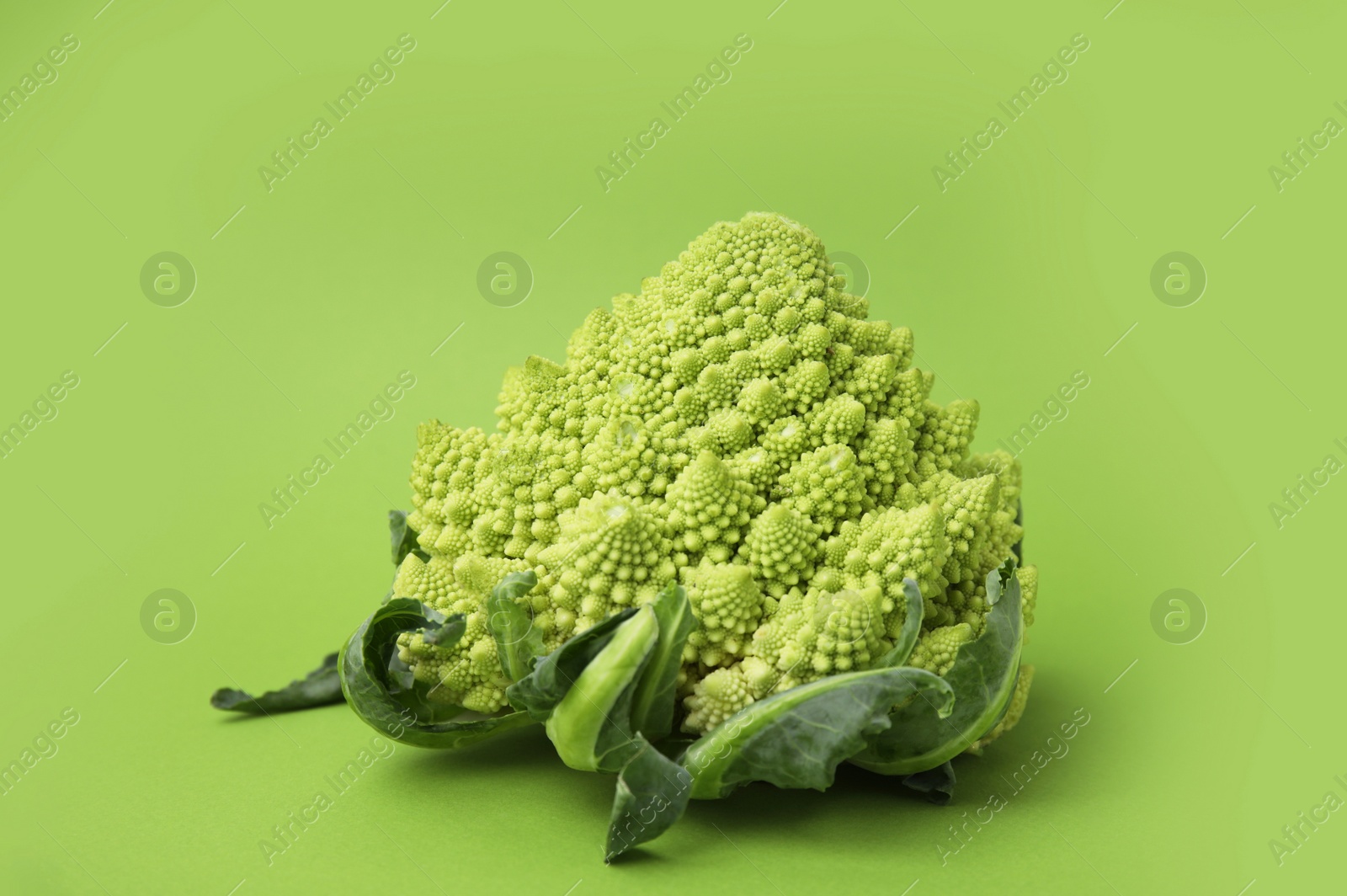 Photo of Fresh raw Romanesco broccoli on green background