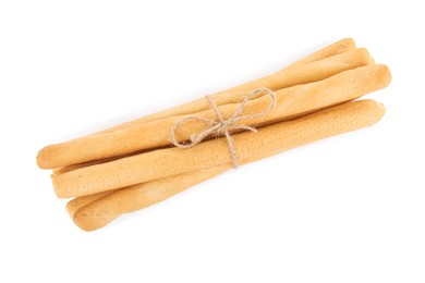 Photo of Fresh delicious grissini sticks on white background, top view