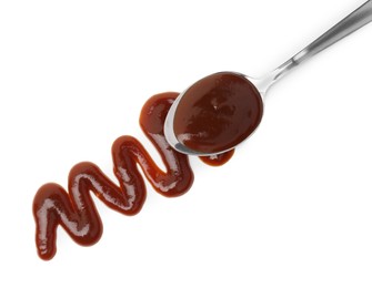 Photo of Tasty barbecue sauce and spoon isolated on white, top view