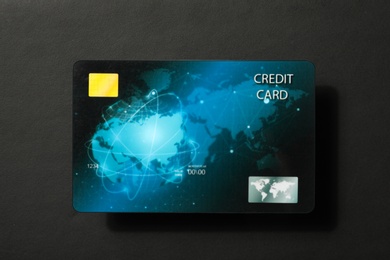 Credit card on black background, top view