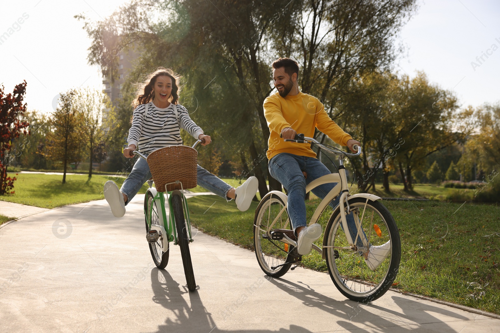 Photo of Beautiful young couple riding bicycles in park