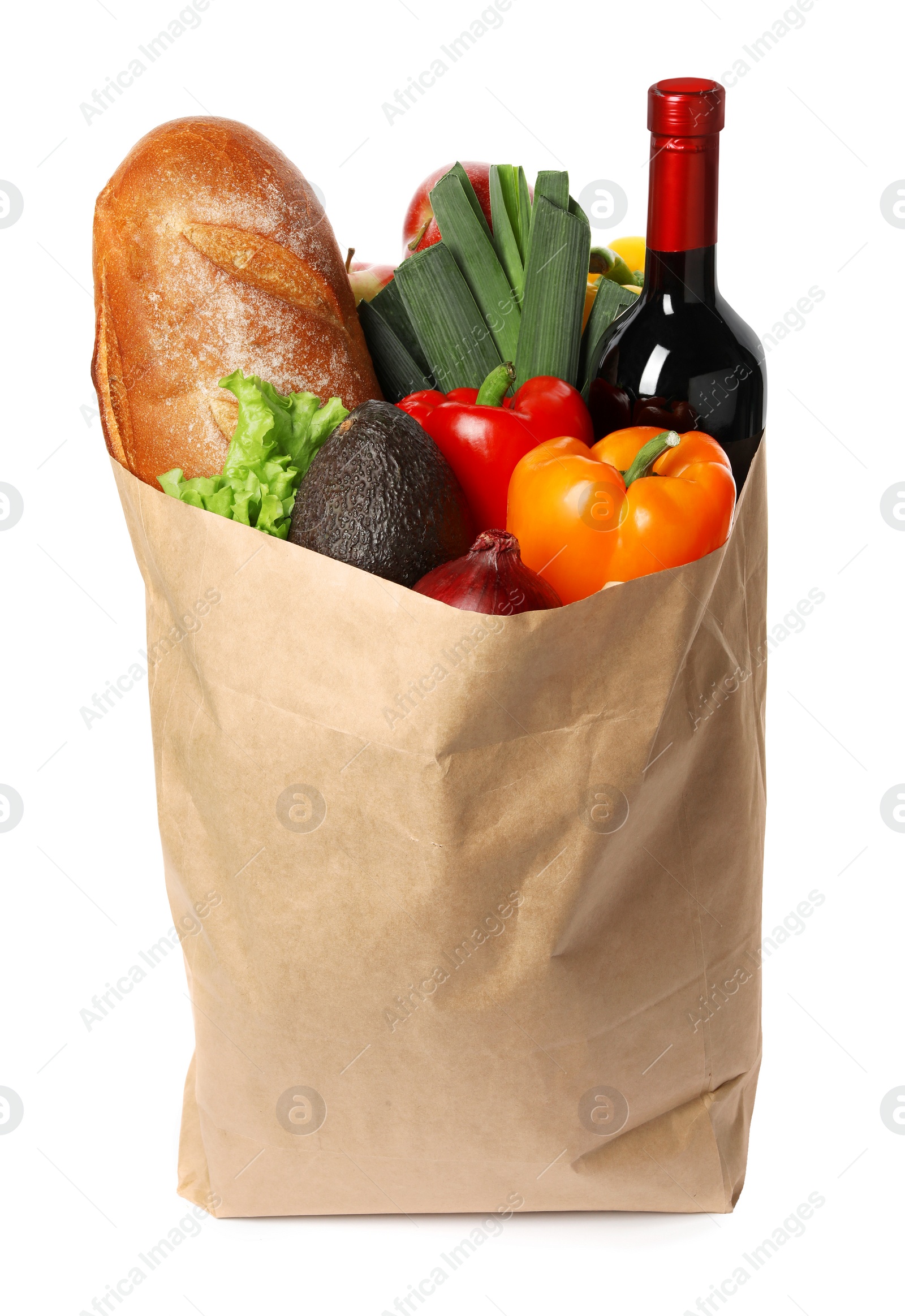 Photo of Paper bag with fresh vegetables, bread and bottle of wine on white background