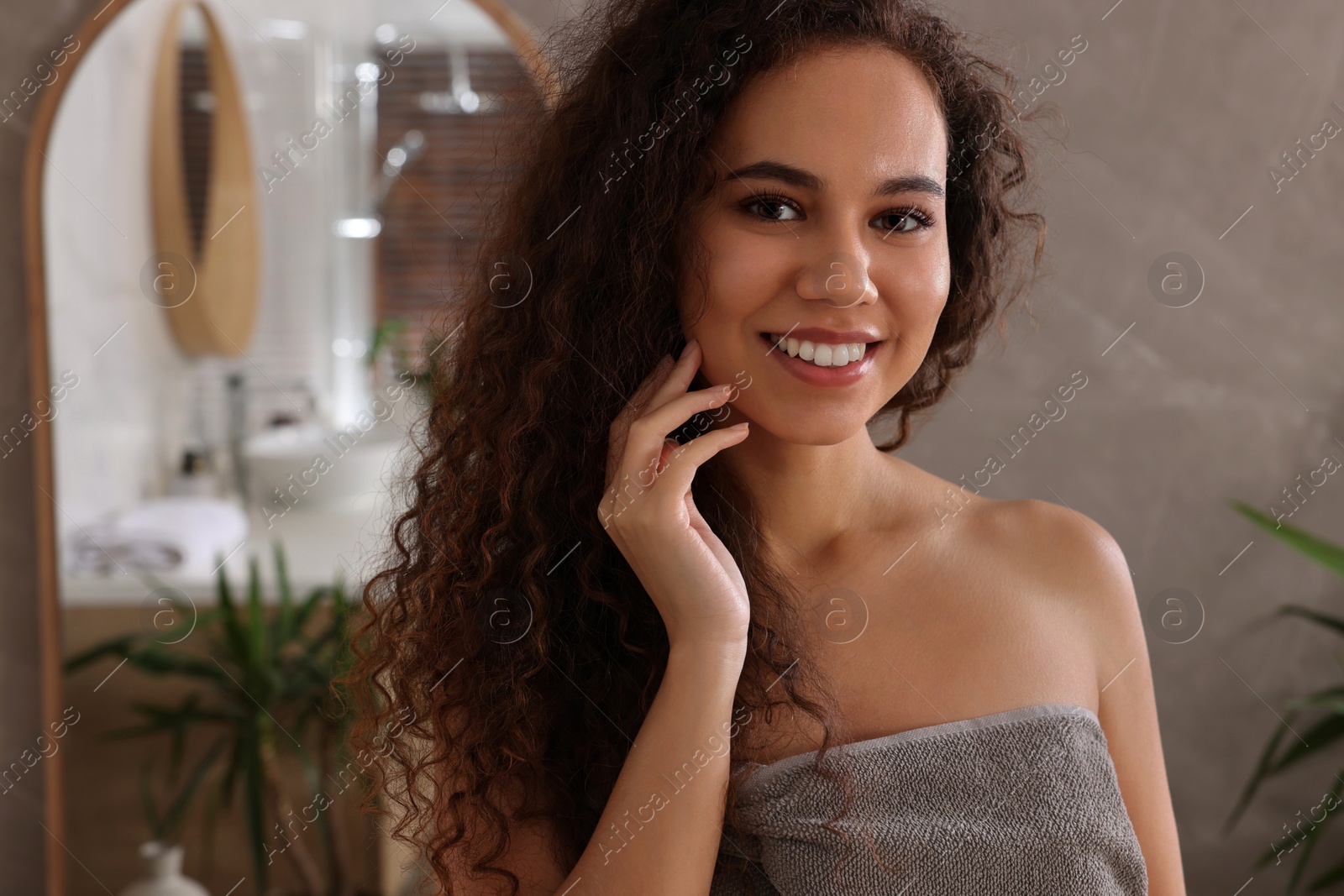 Photo of Beautiful young African American woman in bathroom