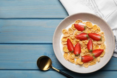 Delicious crispy cornflakes with milk and fresh strawberries on light blue wooden table, flat lay. Space for text