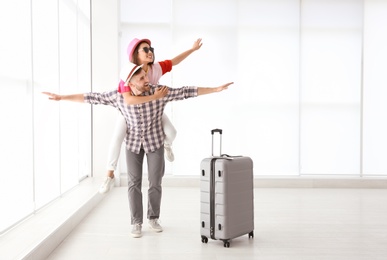 Photo of Young couple with suitcase in airport