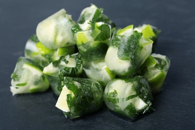 Lime and mint ice cubes on dark background, closeup