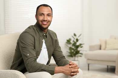 Portrait of handsome young man indoors, space for text