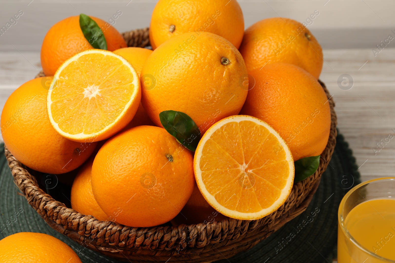 Photo of Many ripe juicy oranges on white wooden table, closeup