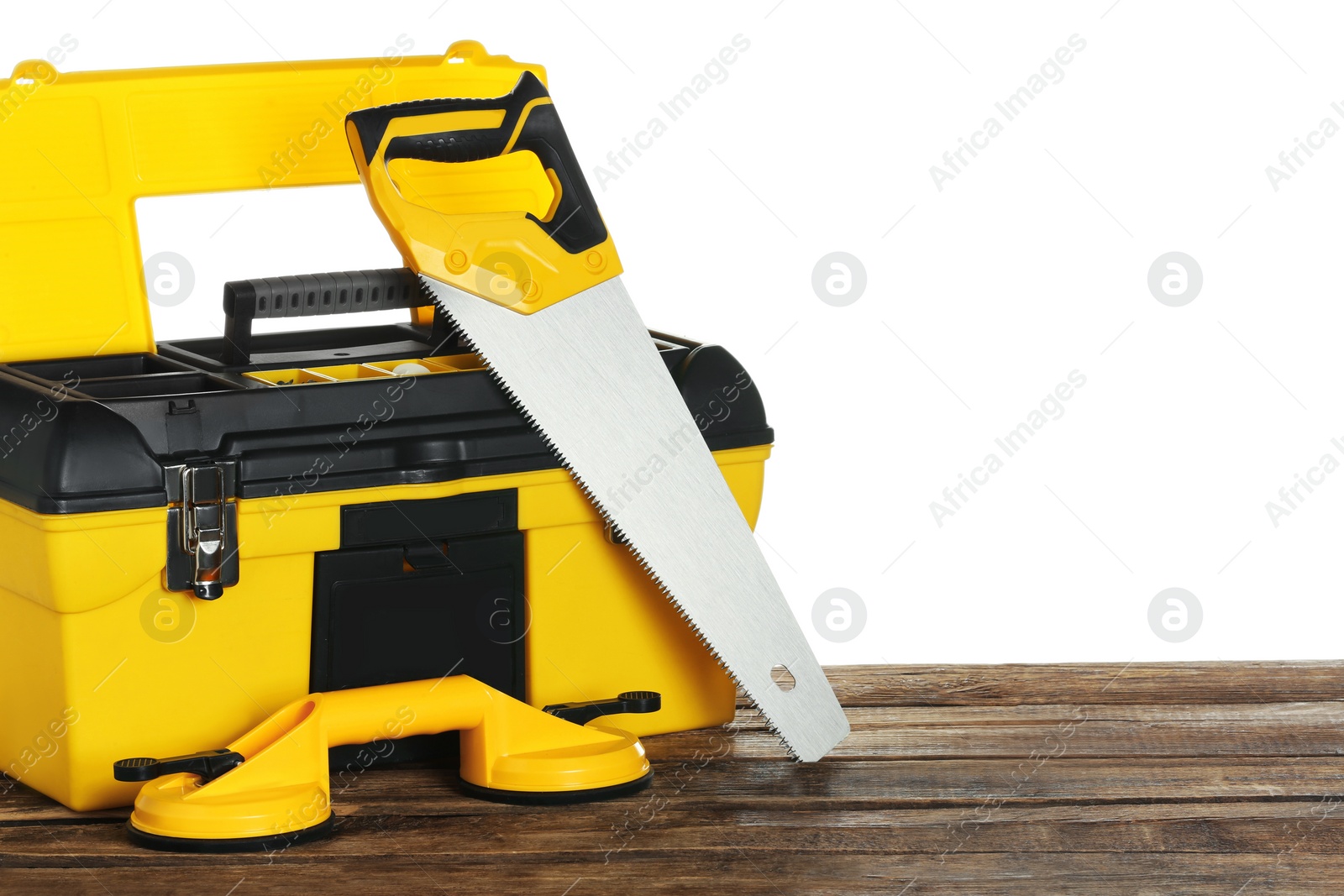 Photo of Plastic box with different tools on wooden table against white background
