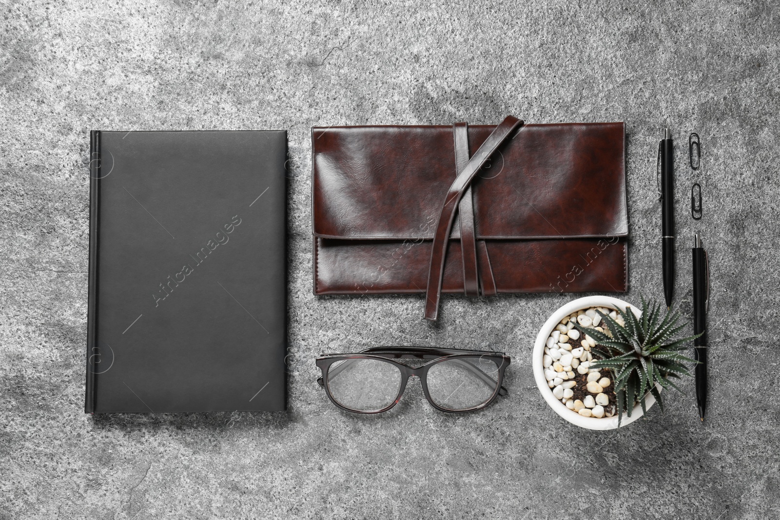 Photo of Flat lay composition with notebook and glasses on grey background