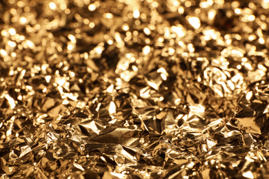 Crumpled gold foil as background, closeup view