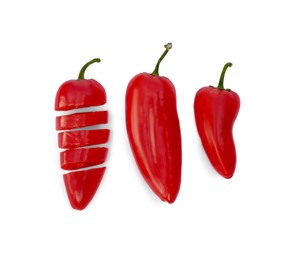 Photo of Whole and cut red hot chili peppers on white background, flat lay