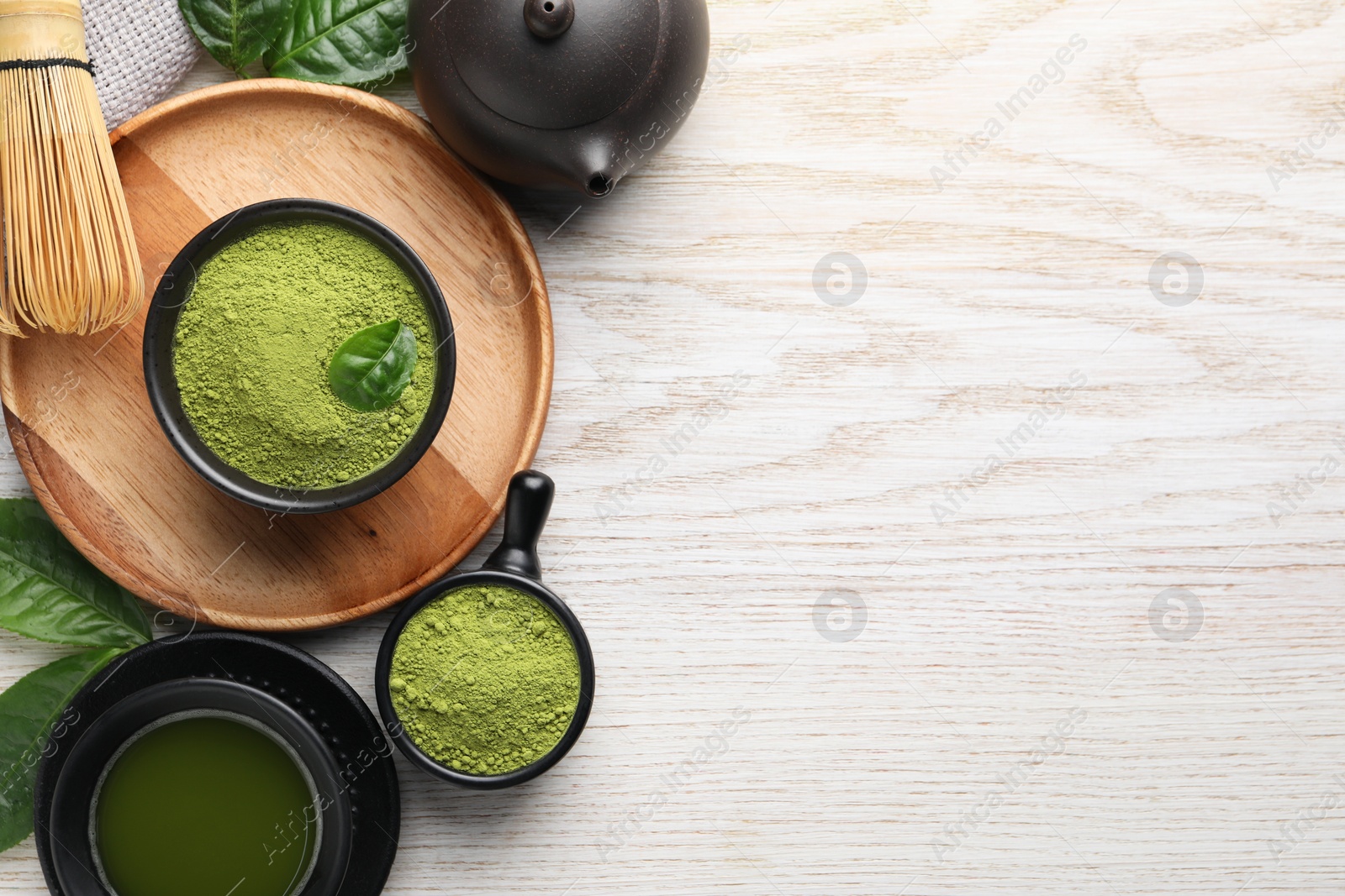 Photo of Flat lay composition with green matcha powder on white wooden table. Space for text