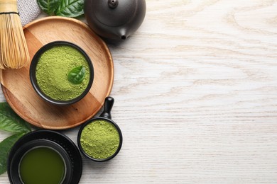 Flat lay composition with green matcha powder on white wooden table. Space for text