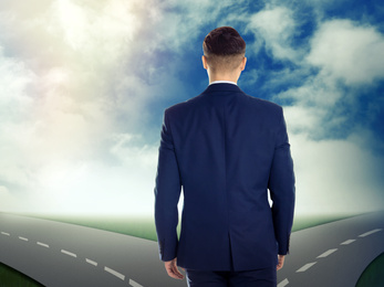 Image of Choose your way. Man standing at crossroads taking important decision
