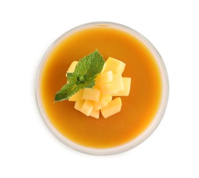Photo of Delicious mango coulis with fresh fruit pieces and mint isolated on white