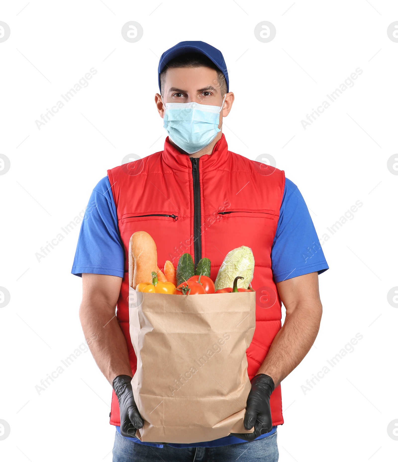 Photo of Courier in medical mask holding paper bag with food on white background. Delivery service during quarantine due to Covid-19 outbreak