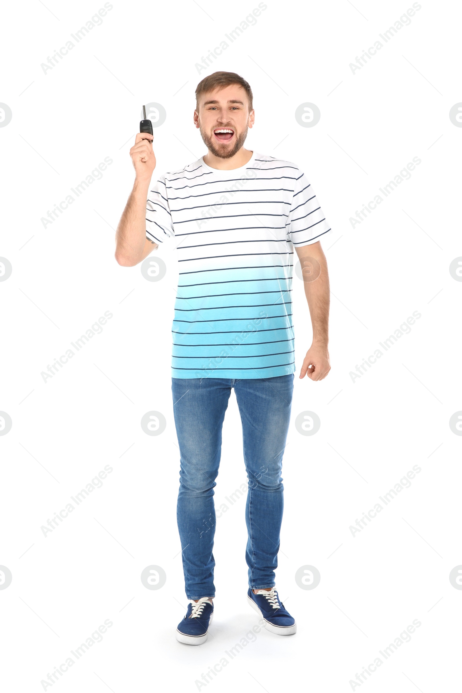 Photo of Happy young man with car key on white background. Getting driving license