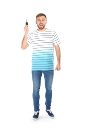 Happy young man with car key on white background. Getting driving license