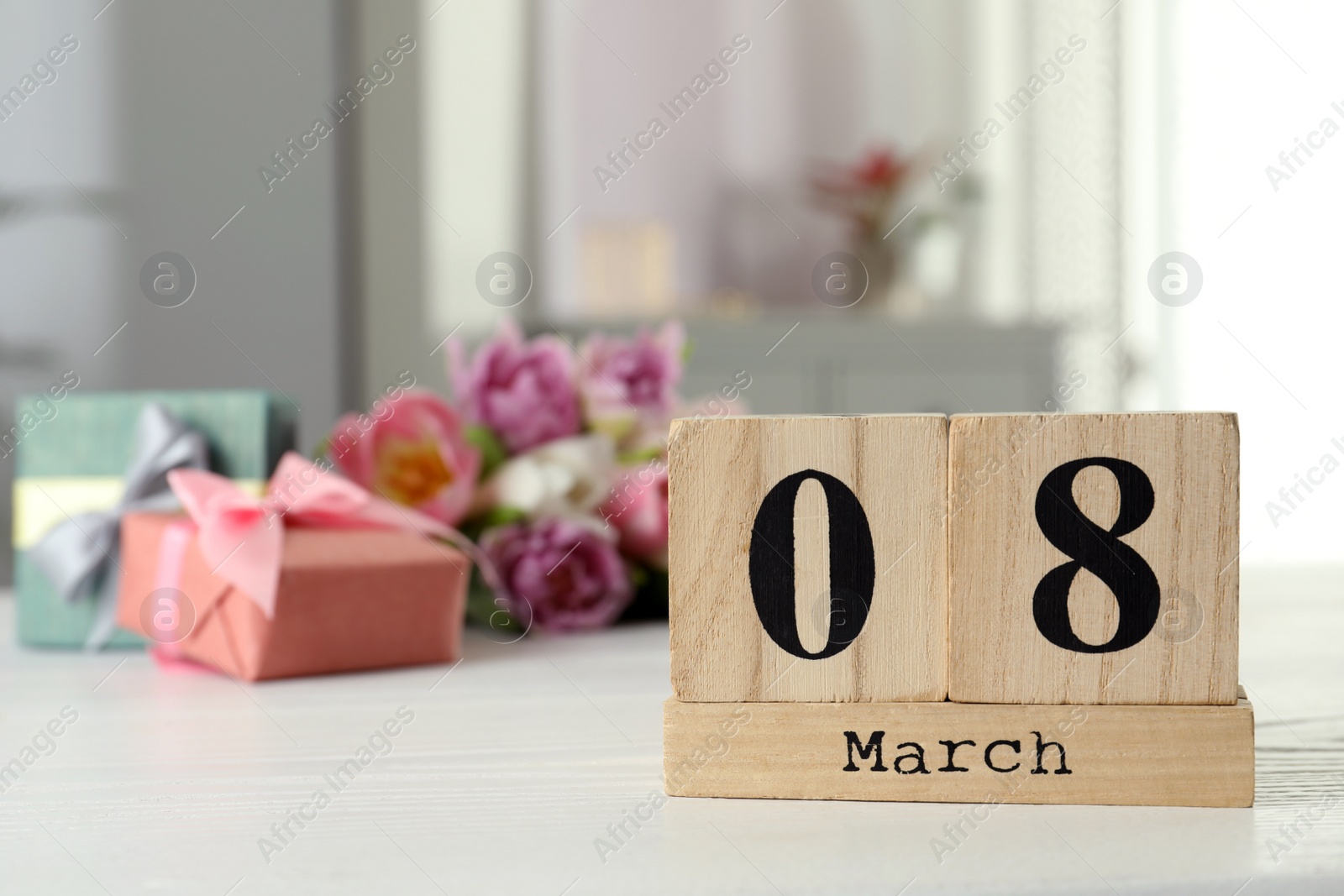 Photo of Wooden block calendar with date 8th of March on table indoors, space for text. International Women's Day