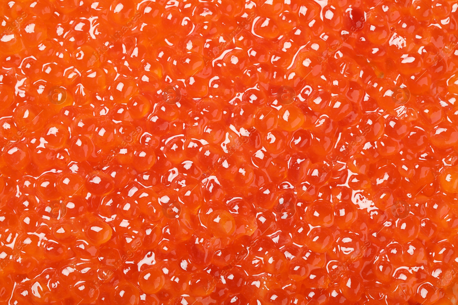 Photo of Delicious red caviar as background, top view