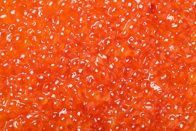 Photo of Delicious red caviar as background, top view