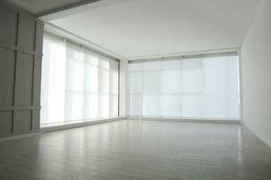 Photo of Empty room with panoramic windows and white wooden floor