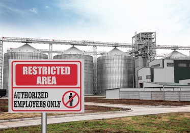 Image of Sign with text Restricted Area Authorized Employees Only near granaries outdoors
