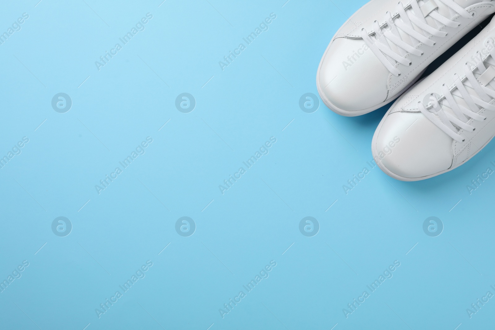 Photo of Pair of sneakers on color background, flat lay. Space for text