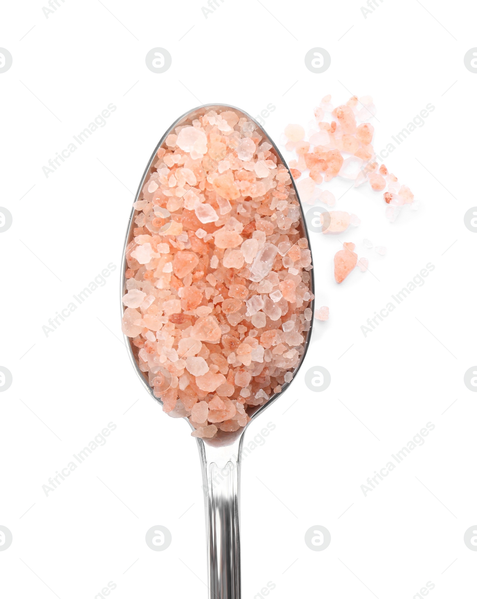 Photo of Metal spoon with pink himalayan salt isolated on white, top view