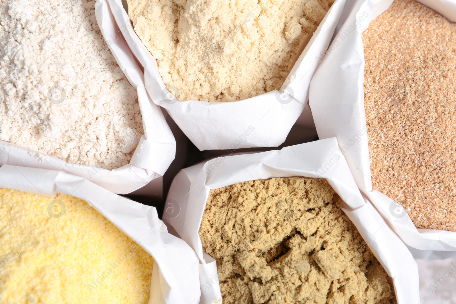 Photo of Paper bags with different types of flour, closeup