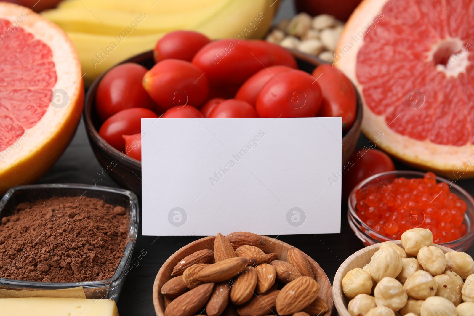 Photo of Many different products with blank card on table, closeup and space for text. Natural sources of serotonin