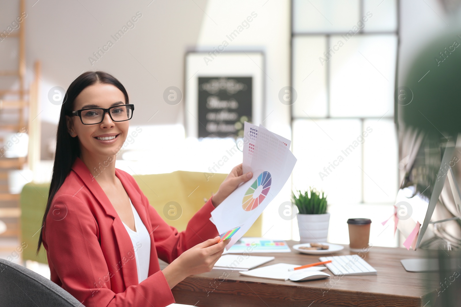 Photo of Female designer working at desk in office