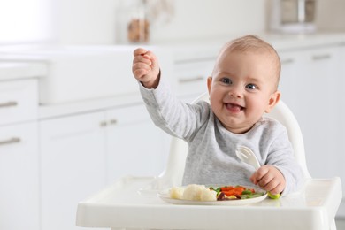 Photo of Cute little baby eating healthy food at home. Space for text